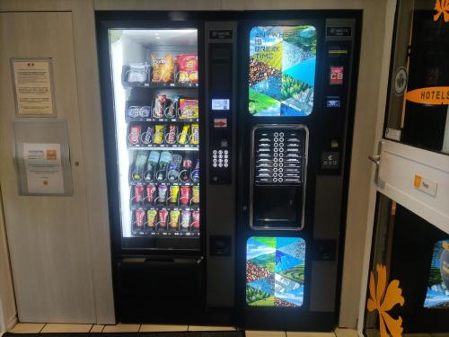 a vending machine filled with drinks and soda at Premiere Classe Vannes in Vannes