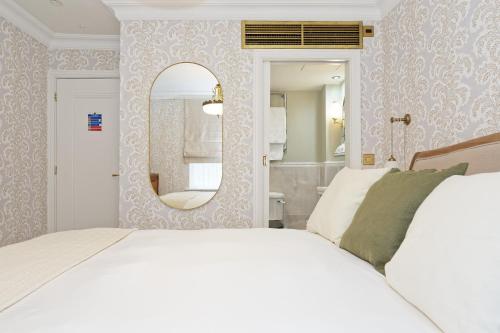 a bedroom with a large bed and a mirror at Old Town House by Ezestays in Margate
