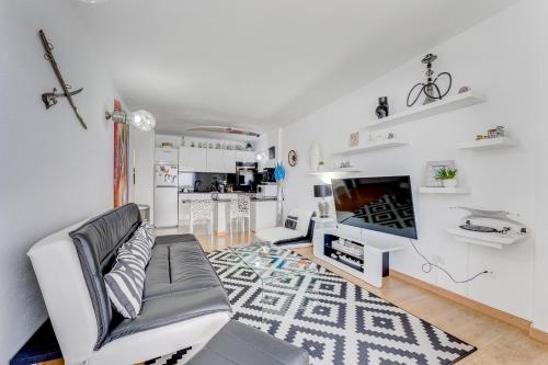 a living room with a couch and a tv at 1st line sea view 3 rooms apartment in Tenerife 92m2 in Bajamar