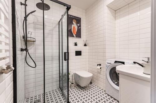 a bathroom with a shower and a toilet at Modern flat in Old Town Kaunas - Free Parking & Self Check-In in Kaunas