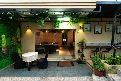 a patio with a table and chairs in a building at Vivera Highlands in Kodaikānāl