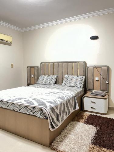 a large bed in a bedroom with a rug at 3 bedrooms flat,fully equipped in Cairo