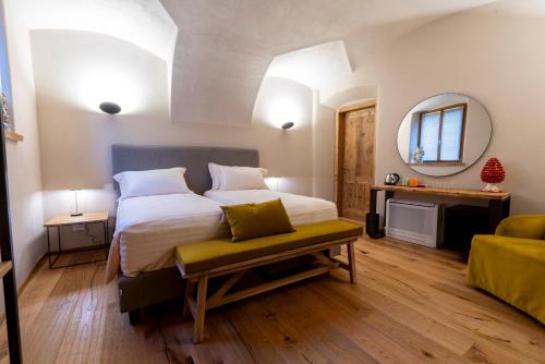 a bedroom with a large bed and a mirror at Relais Villa Carrara in Villa di Serio