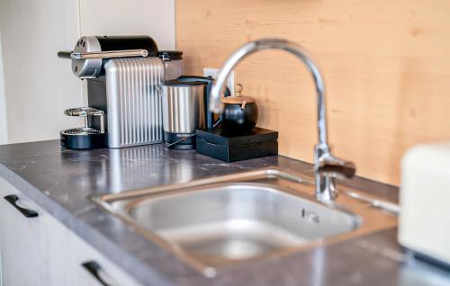 a kitchen counter with a sink and a mixer at Ferienhaus Mit Sauna in Katschberghöhe