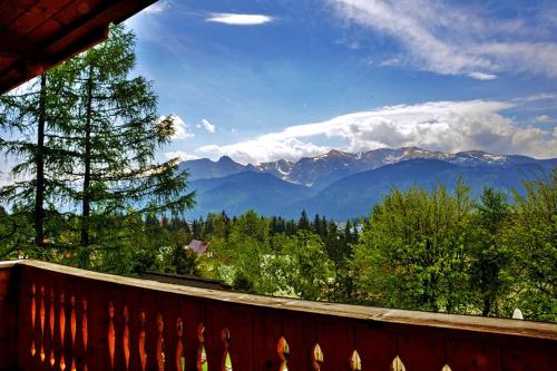 a balcony with a view of a mountain range at Willa Pod Orłem Jacuzzi Sauna in Kościelisko