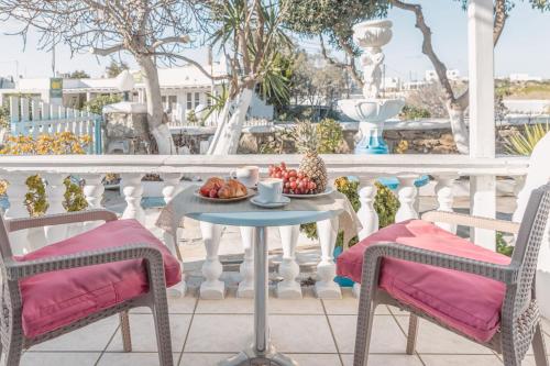 a table with a bowl of fruit on a balcony at Dibellee Mykonos Studios in Glastros