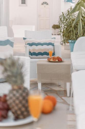 a living room with a table with plates of fruit at Dibellee Mykonos Studios in Glastros