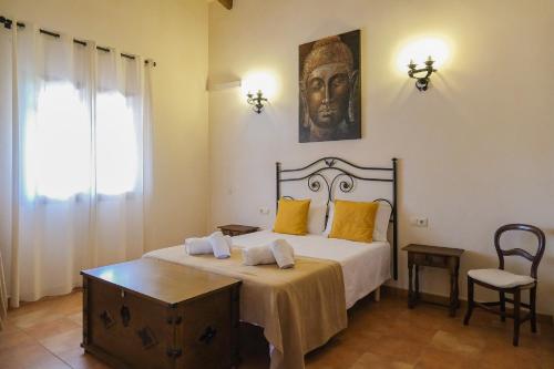 a bedroom with a bed with a statue on the wall at Son Rossinyol by Rentallorca in Sineu