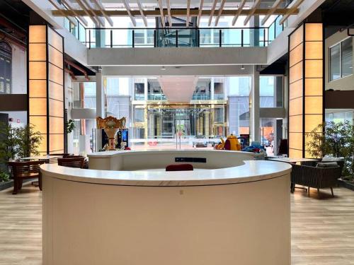 a large lobby with a large building with a circular counter at HillLand Suites in Ayer Keroh