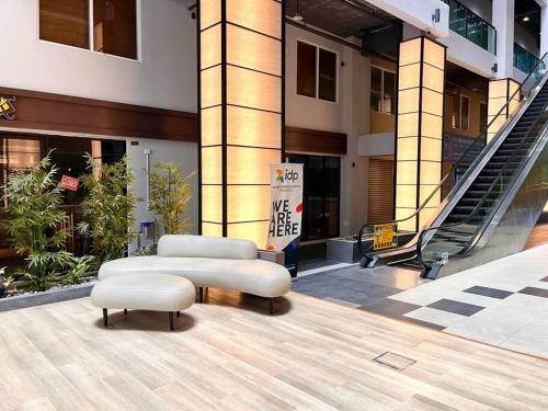 a pair of ottomans sitting in front of a building at HillLand Suites in Ayer Keroh