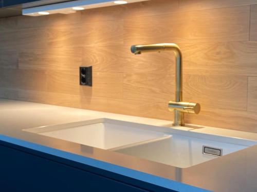 a kitchen sink with a faucet on a counter at Unikt feriested med stor privat brygge in Bamble