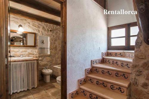 a bathroom with a sink and a toilet and a staircase at Finca Comteses Petit by Rentallorca in Alcudia