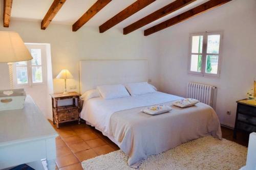 a bedroom with a white bed with two pillows on it at Finca Can Busquera by Rentallorca in Sóller