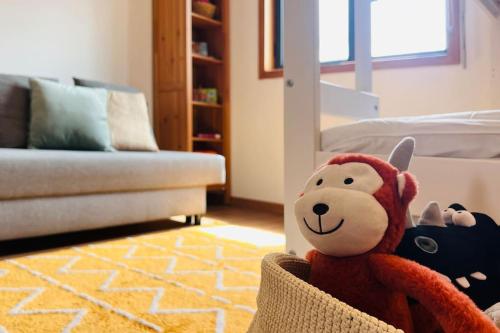 a stuffed animal sitting in a chair in a living room at Postcard View @ Coimbra Downtown in Coimbra