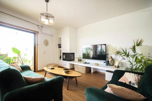 a living room with two couches and a table at Postcard View @ Coimbra Downtown in Coimbra