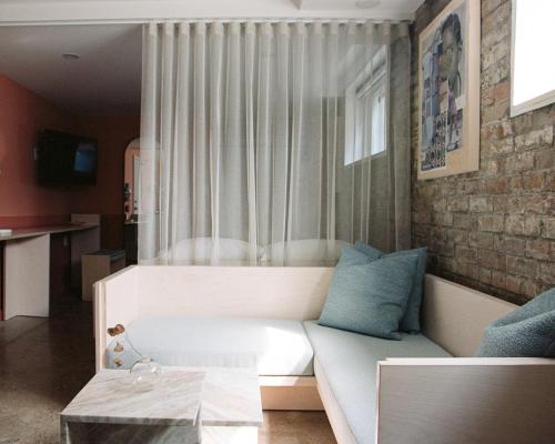 a living room with a white couch with blue pillows at Ode in Toronto