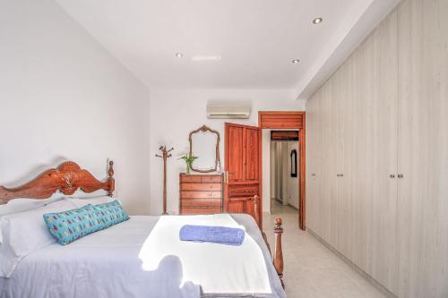 a bedroom with a large bed with a wooden headboard at Villa Can Siulet by Rentallorca in Alcudia