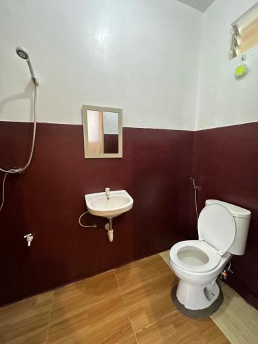 a bathroom with a toilet and a sink at Marz inn Moalboal in Moalboal