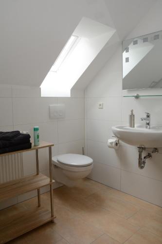 a bathroom with a toilet and a sink at Pension Zum Hirsch in Göda