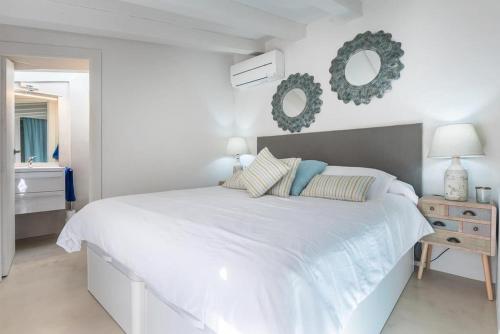 um quarto branco com uma cama grande e um espelho em Sa Caseta by Rentallorca em Sóller
