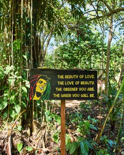 a sign in the middle of a forest at Casa Iris- Home for Family, Steps From the Beach, Pool and Yoga Deck in Puerto Viejo