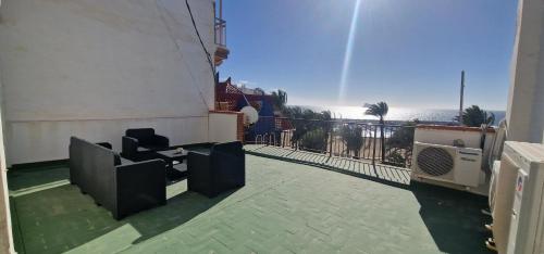 a room with a balcony with a view of the ocean at SAN PEDRO 2 - Fincas Arena in Benidorm