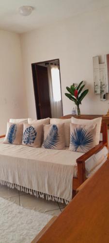a bedroom with a bed with blue and white pillows at Casa Mathia in Caraíva