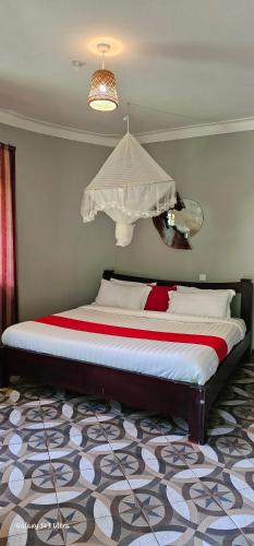 a bedroom with a large bed in a room at Tusubira village in Jinja