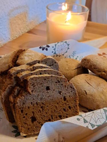 a plate of bread on a table with a candle at Naturetouch in Steinberg am Rofan