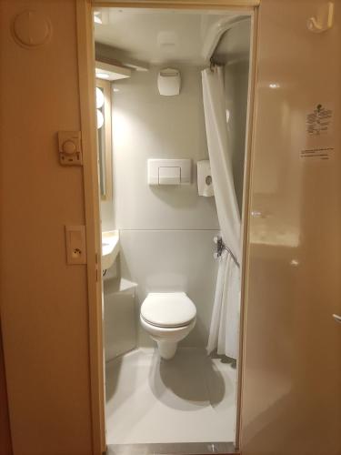 a small bathroom with a toilet and a sink at Premiere Classe Vannes in Vannes