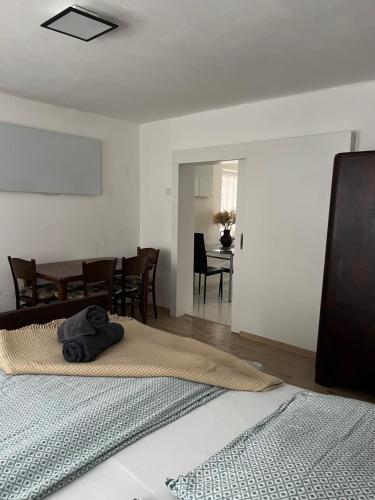 a bedroom with a bed and a dining room at Chalupa na Lípové v Hlohovci in Hlohovec