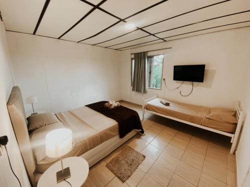 1 dormitorio con 1 cama y TV de pantalla plana en Departamento Nórdico en Posadas