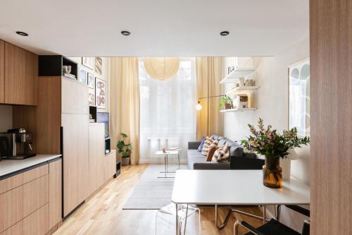 a kitchen and living room with a couch and a table at TurnKey I Charles Square Apartments in Prague