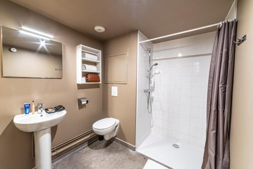 a bathroom with a toilet sink and a shower at Montempô Apparthôtel Strasbourg in Strasbourg