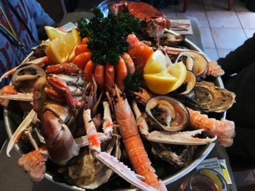 a plate of seafood and vegetables on a table at gîte de la scierie in Saint-Gâtien-des-Bois