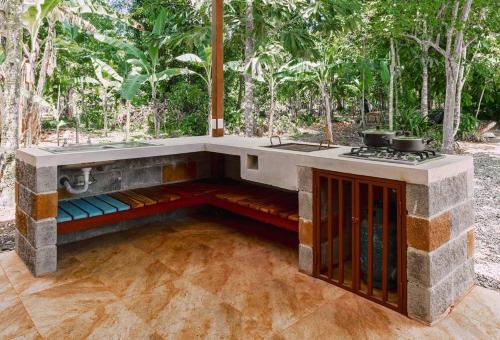 an outdoor kitchen with a counter and a stove at Casa Iris- Home for Family, Steps From the Beach, Pool and Yoga Deck in Puerto Viejo