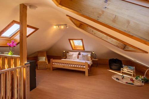 een slaapkamer met een bed op zolder bij Nature Retreat Pool, Hot Tub, Sauna, Hiking-Caves in Hohenfels-Essingen