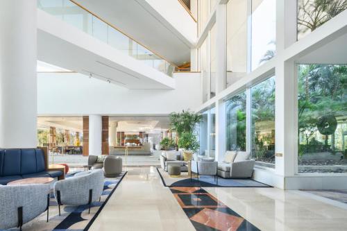 a lobby with couches and chairs in a building at Royal Beach Eilat by Isrotel Exclusive in Eilat