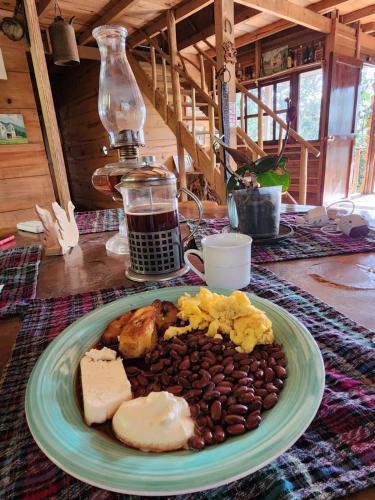 a plate of food with eggs and beans on a table at Paraiso Verde in Chijoú