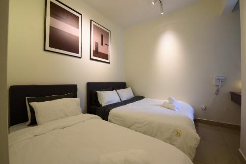 two beds in a hotel room with a teddy bear on them at Myuko Homestay (2-7 pax) 10min to BOH in Brinchang