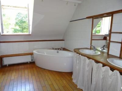 a bathroom with two sinks and a large tub at Domaine de la Haute Justerie - piscine & billard à l’orée des bois - Loire Valley in Fondettes