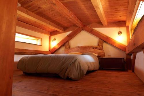 a bedroom with a bed in a room with wooden ceilings at Timber frame guesthouse in NE Portland in Portland