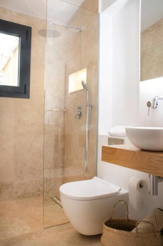 a bathroom with a shower and a toilet and a sink at YourHouse Iris House in Colonia de Sant Pere