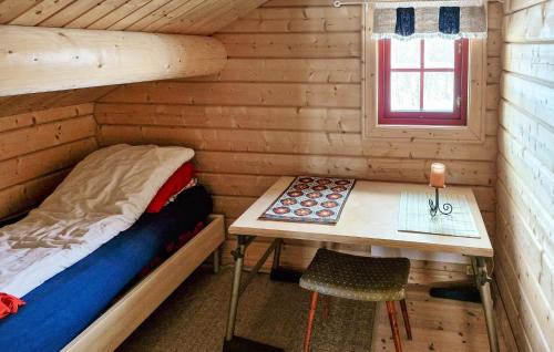 a bedroom with a bed and a desk in a log cabin at 4 Bedroom Pet Friendly Home In Tydal in Tydal