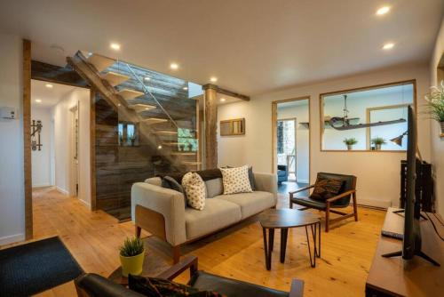a living room with a couch and a table at Le Repere Etoile au coeur de la nature in Sainte-Lucie-de-Doncaster