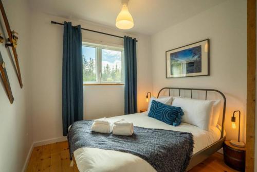 a bedroom with a bed with two pillows on it at Le Repere Etoile au coeur de la nature in Sainte-Lucie-de-Doncaster