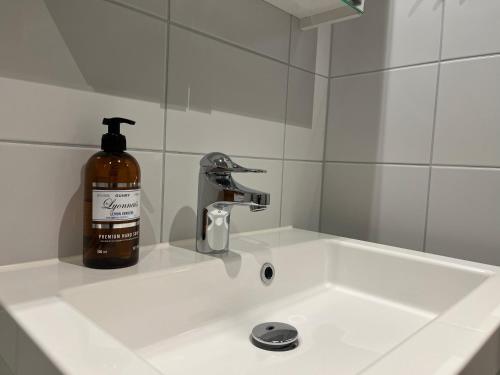 a soap bottle sitting on top of a bathroom sink at Funäs Fjällby Funäsdalen in Funäsdalen