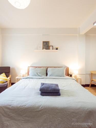 a large white bed with a blue towel on it at 206HiddenNest, Local Room with Street Food only 15 min walk to Skytrain in Bangkok