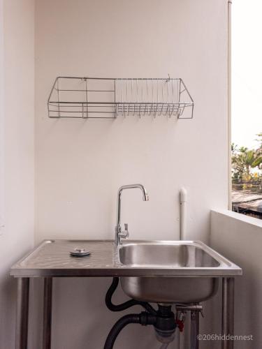 a stainless steel sink in a kitchen next to a window at 206HiddenNest, Local Room with Street Food only 15 min walk to Skytrain in Bangkok