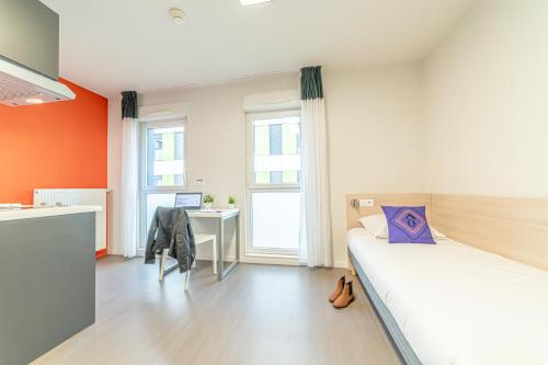トゥールーズにあるMontempô Apparthôtel Toulouse Balmaのベッドルーム1室(ベッド1台、デスク、コンピュータ付)